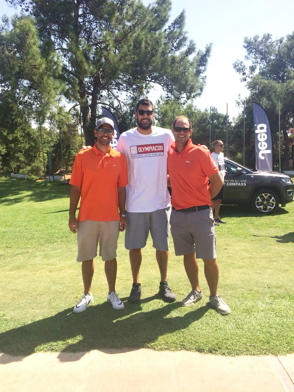 Golf Events 18 team beside event banners outdoors